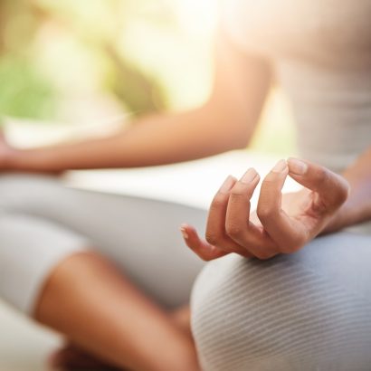 Cropped shot of a sporty young woman practicing yoga outdoors.